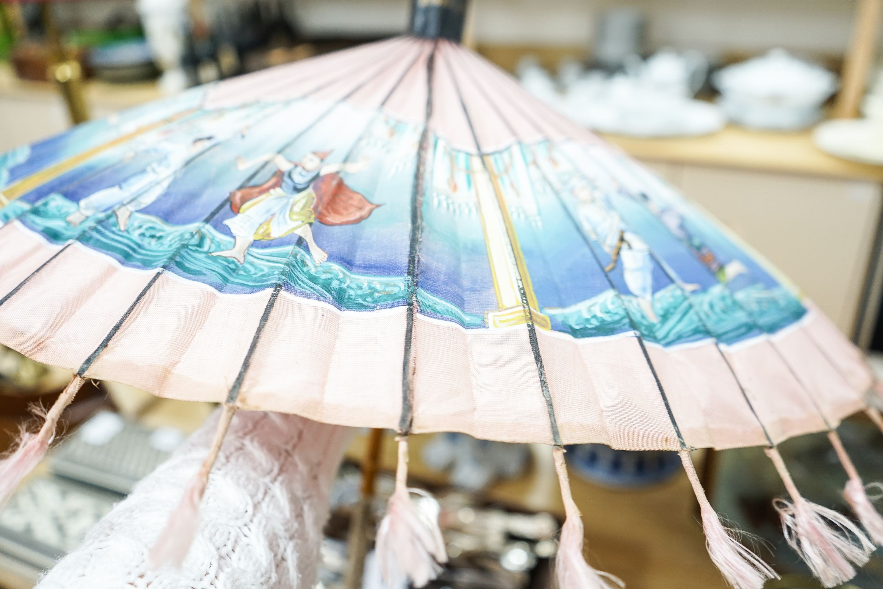 A 19th century Chinese Canton export ivory parasol with carved Ivory handle and a Burmese white metal handled painted fabric parasol